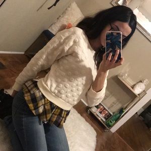 Cream sweater with plaid peplum underlay